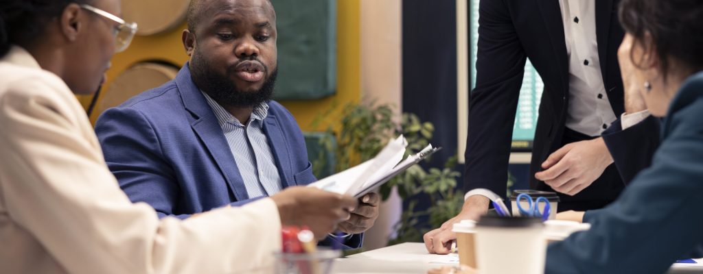 Business leader trying to eliminate risks of unforeseen obstacles and disruptions, discussing supply chain resilience and management. Manager and staff members achieving success.